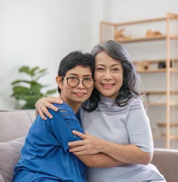 two-women-embracing-on-a-sofa-indoors