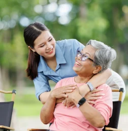young-woman-hugging-senior-woman-in-a-park